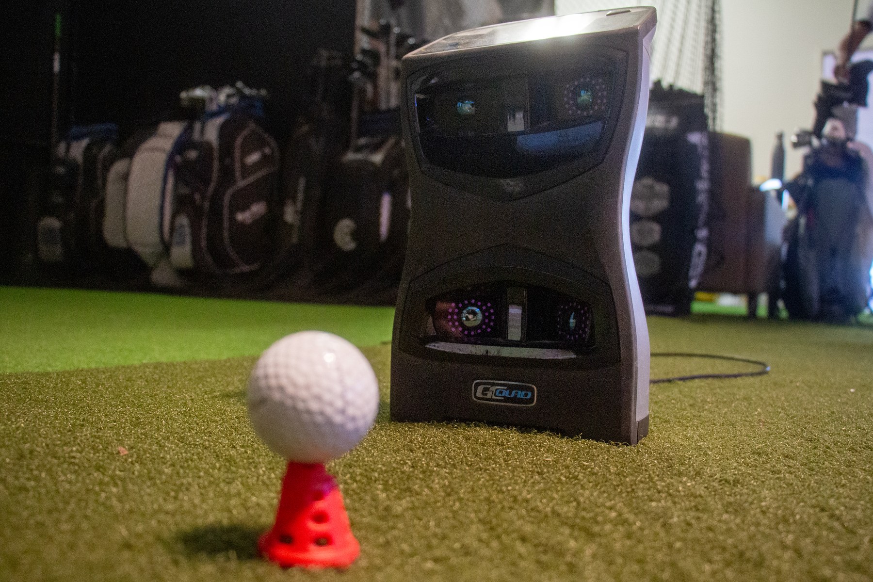 GCQuad launch monitor beside a golf ball in the Alameda Golfworks fitting area