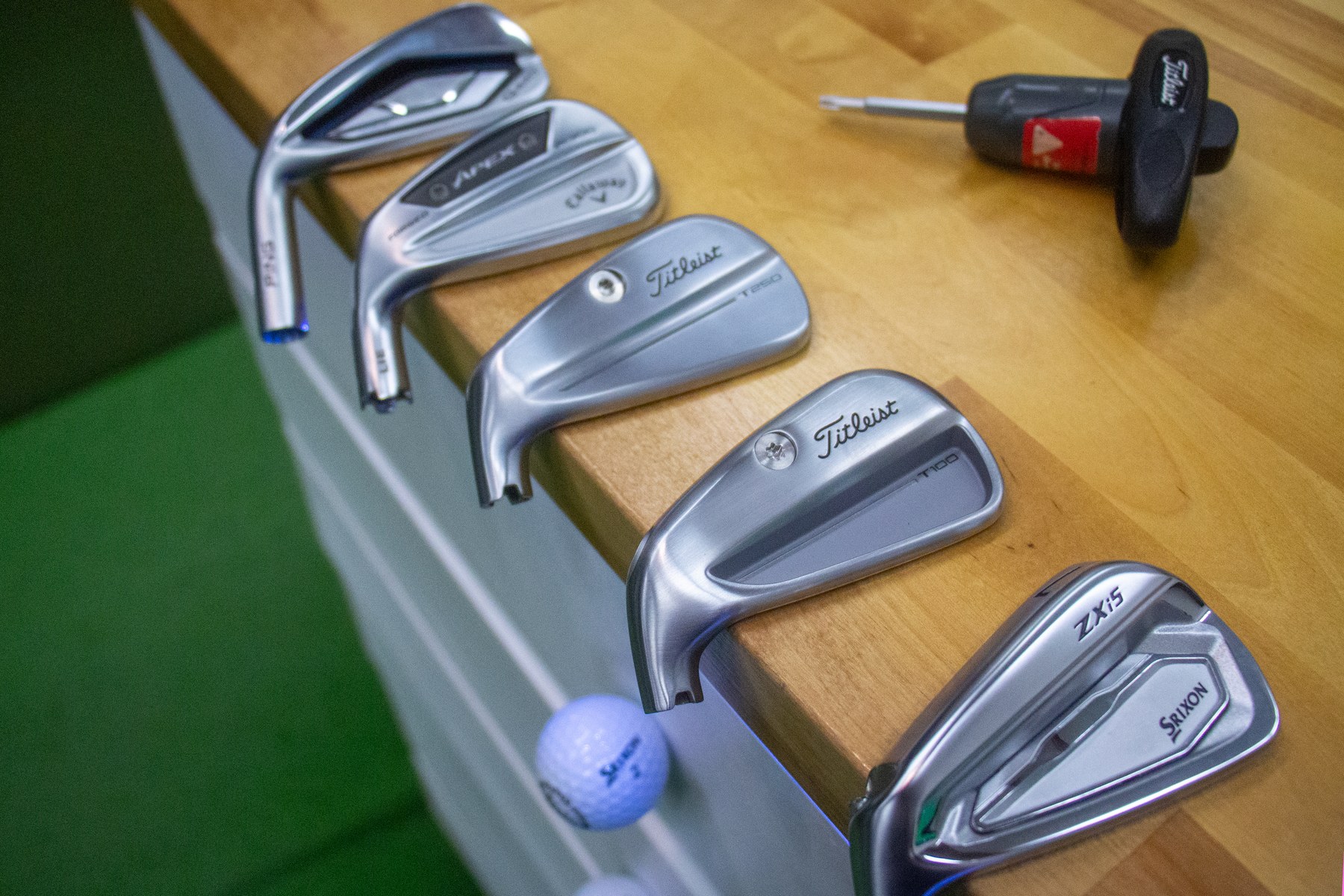 Iron heads from several manufacturers on the Alameda Golfworks fitting bench