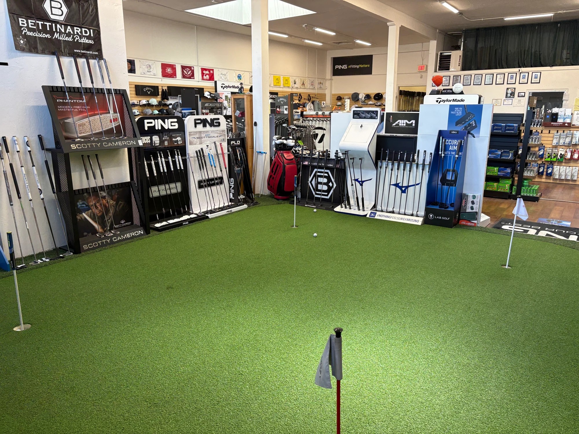 Putting green and putter selection at Alameda Golfworks