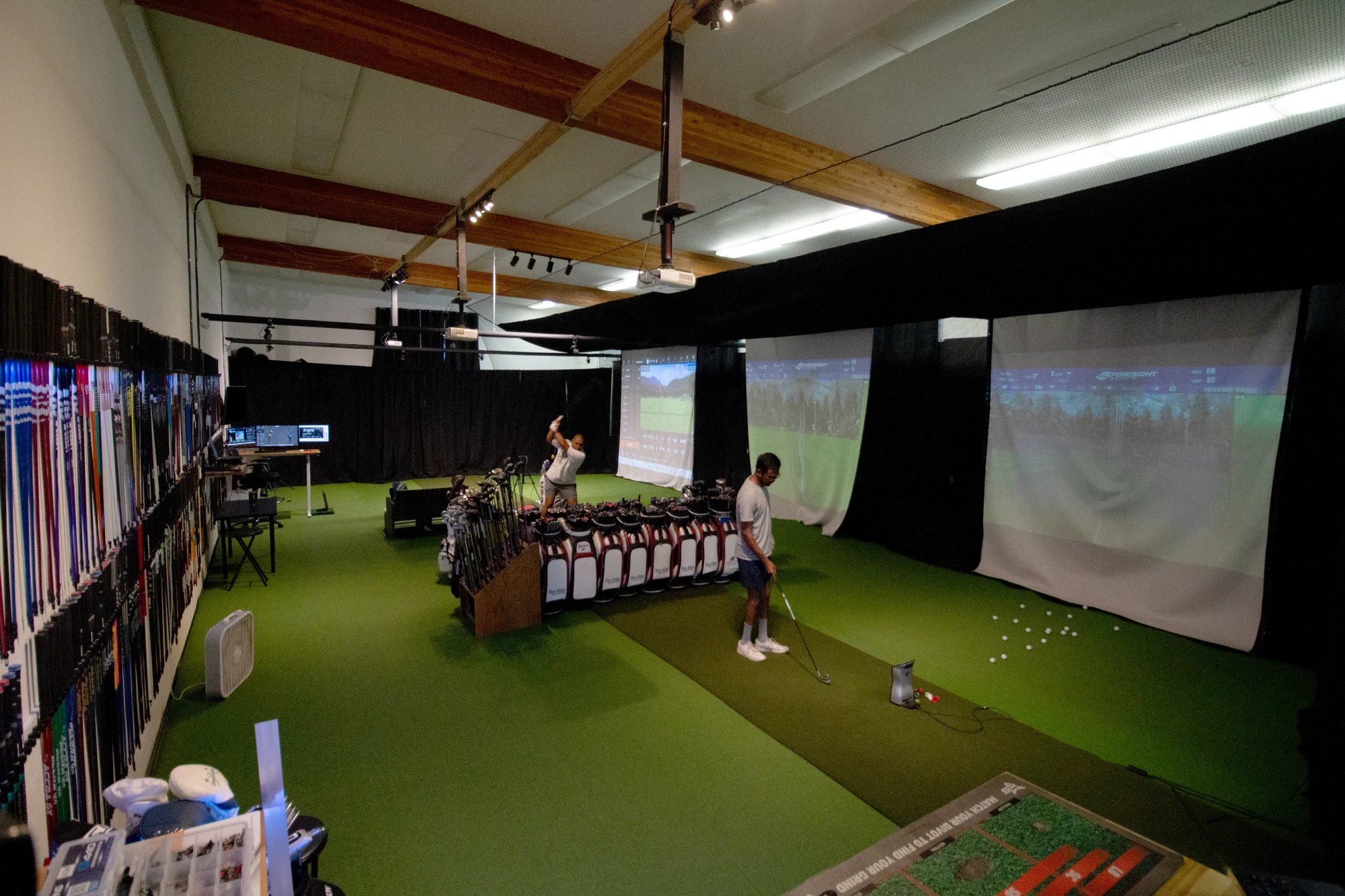 Indoor club fitting bays and equipment at Alameda Golfworks